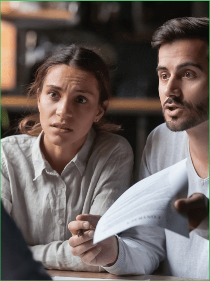 Couple discussing document with another person