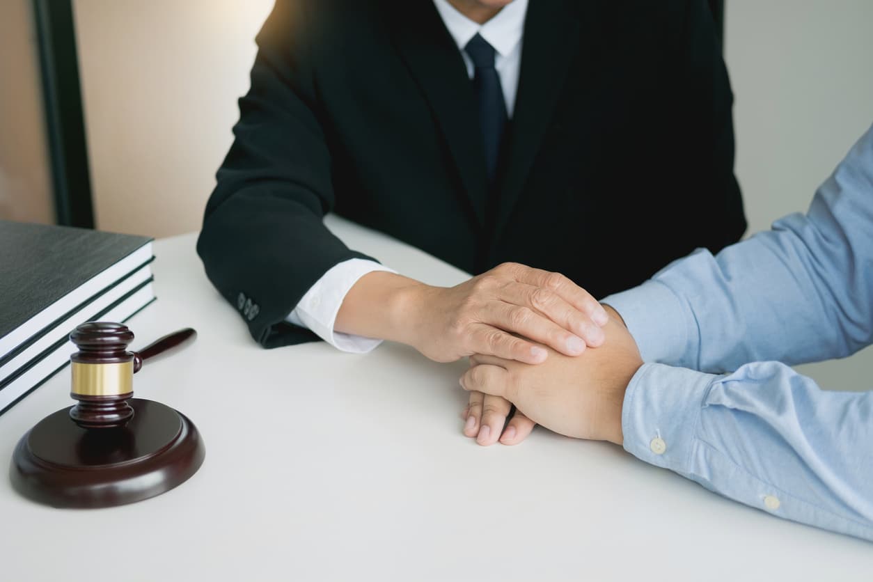 Justice and Law concept. consultant holding client hands in law firm
